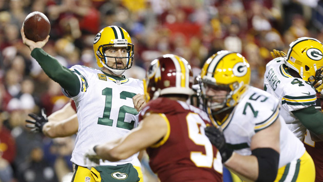 Jan 10, 2016; Landover, MD, USA; Green Bay Packers quarterback Aaron Rodgers (12) throws the ball over Washington Redskins outside linebacker Ryan Kerrigan (91) during the first half in a NFC Wild Card playoff football game at FedEx Field. Mandatory Credit: Geoff Burke-USA TODAY Sports
