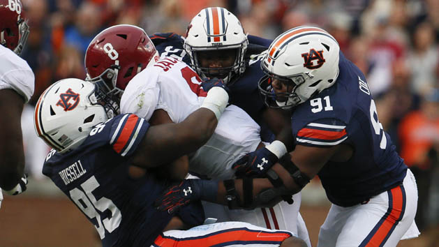 Nov 25, 2017; Auburn, AL, USA; Alabama Crimson Tide running back Josh Jacobs (8) is brought down by Auburn Tigers defensive lineman Dontavius Russell (95) and defensive lineman Nick Coe (91) during the second quarter at Jordan-Hare Stadium. Photo Credit: John Reed-USA TODAY Sports