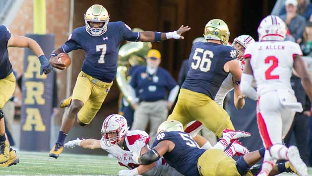 Sep 30, 2017; South Bend, IN, USA;Notre Dame Fighting Irish quarterback Brandon Wimbush (7) runs with the abll while Miami (Oh) Redhawks linebacker Brad Koenig (38) defends in the first half of the game at Notre Dame Stadium. Photo Credit: Trevor Ruszkowski-USA TODAY Sports