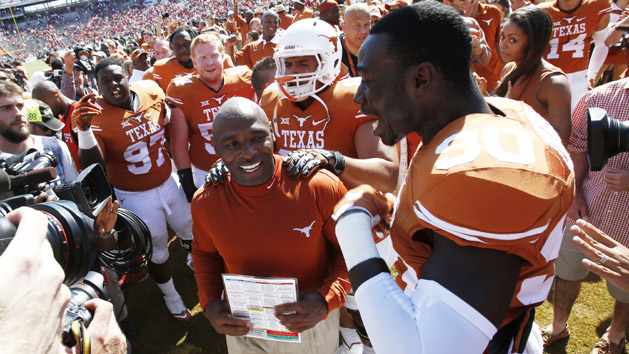 Charlie Strong is surrounded by his players after the game against the Oklahoma Sooners during the Red River rivalry at Cotton Bowl Stadium last year. Texas won 24-17. Photo Credit: Tim Heitman-USA TODAY Sports
