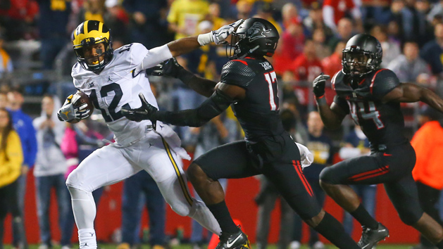 Oct 8, 2016; Piscataway, NJ, USA; Michigan Wolverines running back Chris Evans (12) runs with the ball while avoiding a tackle attempt by Rutgers Scarlet Knights defensive back K.J. Gray (17) during the second half at High Points Solutions Stadium. Michigan defeated Rutgers 78-0. Photo Credit: Ed Mulholland-USA TODAY Sports