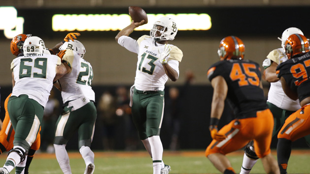 Nov 21, 2015; Stillwater, OK, USA; Baylor Bears quarterback Chris Johnson (13) throws a touchdown pass in the third quarter against the Oklahoma State Cowboys at Boone Pickens Stadium. Baylor won 45-35. Mandatory Credit: Tim Heitman-USA TODAY Sports