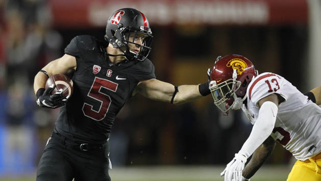 Dec 5, 2015; Santa Clara, CA, USA; Stanford Cardinal running back Christian McCaffrey (5) tries to avoid being tackled by Southern California Trojans cornerback Kevon Seymour (13) after running for a first down in the second quarter in the Pac-12 Conference football championship game at Levi's Stadium. Mandatory Credit: Cary Edmondson-USA TODAY Sports