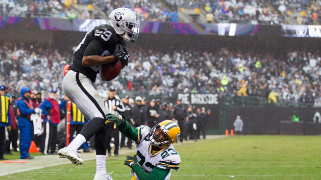 Dec 20, 2015; Oakland, CA, USA; Oakland Raiders wide receiver Amari Cooper (89) catches the ball for a touchdown against Green Bay Packers cornerback Damarious Randall (23) during the third quarter at O.co Coliseum. The Green Bay Packers defeated the Oakland Raiders 30-20. Mandatory Credit: Kelley L Cox-USA TODAY Sports