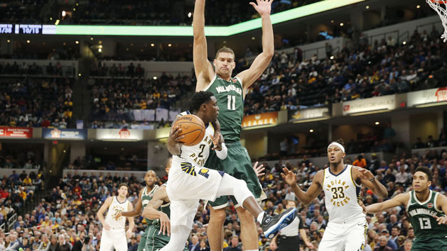 Dec 12, 2018; Indianapolis, IN, USA; Indiana Pacers guard Darren Collison (2) passes the ball around Milwaukee Bucks center Brook Lopez (4) during the third quarter at Bankers Life Fieldhouse. Photo Credit: Brian Spurlock-USA TODAY Sports