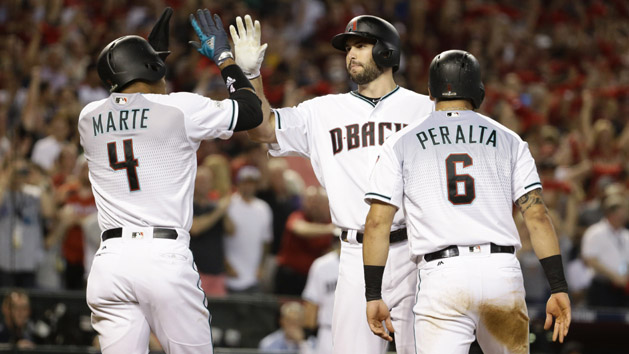 Oct 4, 2017; Phoenix, AZ, USA; Arizona Diamondbacks first baseman Paul Goldschmidt (middle) reacts after hitting a three-run home run to drive in shortstop Ketel Marte (4) and outfielder David Peralta (6) against the Colorado Rockies in the first inning of the 2017 National League wildcard playoff baseball game at Chase Field. Photo Credit: Rob Schumacher/The Arizona Republic via USA TODAY NETWORK