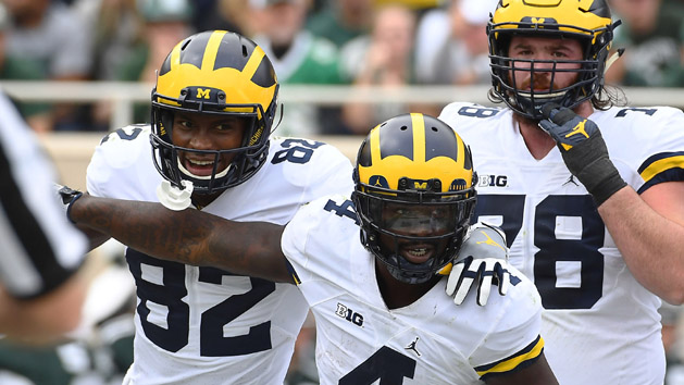 Oct 29, 2016; East Lansing, MI, USA; Michigan Wolverines running back De'Veon Smith (4) celebrates with wide receiver Amara Darboh (82) after scoring a touchdown against the Michigan State Spartans during the first half at Spartan Stadium. Photo Credit: Brad Mills-USA TODAY Sports