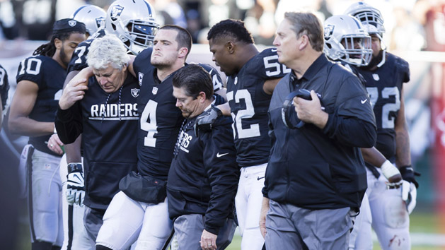 Dec 24, 2016; Oakland, CA, USA; Oakland Raiders quarterback Derek Carr (4) is helped off the field during the fourth quarter against the Indianapolis Colts at the Oakland Coliseum. The Oakland Raiders defeated the Indianapolis Colts 33-25. Photo Credit: Kelley L Cox-USA TODAY Sports