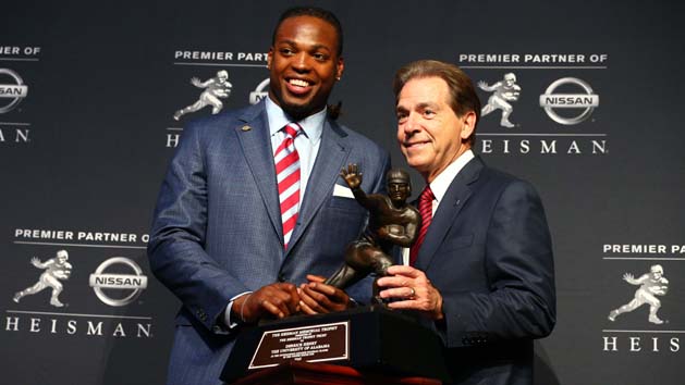 Dec 12, 2015; New York, NY, USA; Alabama running back Derrick Henry (left) and head coach Nick Saban pose with the Heisman Trophy during a press conference at the New York Marriott Marquis after the 81st annual Heisman Trophy presentation. Mandatory Credit: Brad Penner-USA TODAY Sports