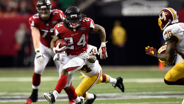 Oct 11, 2015; Atlanta, GA, USA; Atlanta Falcons running back Devonta Freeman (24) runs against Washington Redskins strong safety Trenton Robinson (34) during the second quarter at the Georgia Dome. Mandatory Credit: Dale Zanine-USA TODAY Sports