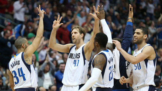Mar 20, 2016; Dallas, TX, USA; Dallas Mavericks forward Dirk Nowitzki (41) celebrates with teammates after scoring a three point basket in overtime against the Portland Trail Blazers at American Airlines Center. The Mavs beat the Trail Blazers 132-120. Mandatory Credit: Matthew Emmons-USA TODAY Sports
