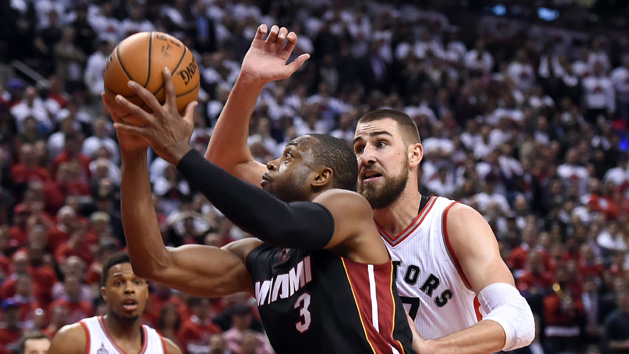 May 3, 2016; Toronto, Ontario, CAN; Miami Heat guard Dwyane Wade (3) shoots past Toronto Raptors guard Jonas Valanciunas (17) in game one of the second round of the NBA Playoffs at Air Canada Centre. The Heat won 102 -96 in overtime. Photo Credit: Dan Hamilton-USA TODAY Sports