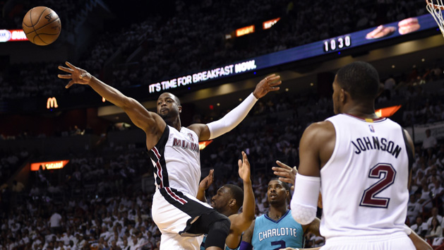 Apr 20, 2016; Miami, FL, USA; Miami Heat guard Dwyane Wade (3) passes the ball to forward Justise Winslow (not pictured) for a three point basket as Charlotte Hornets guard Courtney Lee (1) looks on in game two of the first round of the NBA Playoffs during the second quarter at American Airlines Arena. Mandatory Credit: Steve Mitchell-USA TODAY Sports