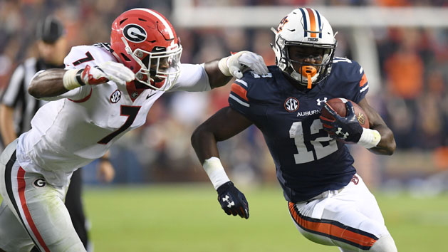 Nov 11, 2017; Auburn, AL, USA; Auburn Tigers wide receiver Eli Stove (12) carries up the field against Georgia Bulldogs linebacker Lorenzo Carter (7) during the third quarter at Jordan-Hare Stadium. Photo Credit: John David Mercer-USA TODAY Sports