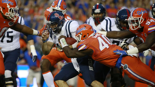 Oct 3, 2015; Gainesville, FL, USA; Mississippi Rebels quarterback Chad Kelly (10) gets tackled by Florida Gators linebacker Jarrad Davis (40) during the first quarter at Ben Hill Griffin Stadium. Mandatory Credit: Kim Klement-USA TODAY Sports