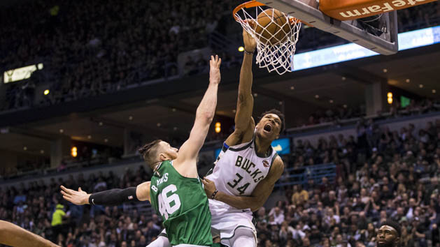 Apr 20, 2018; Milwaukee, WI, USA; Milwaukee Bucks forward Giannis Antetokounmpo (34) dunks over Boston Celtics center Aron Baynes (46) during the third quarter in game three of the first round of the 2018 NBA Playoffs at BMO Harris Bradley Center. Photo Credit: Jeff Hanisch-USA TODAY Sports