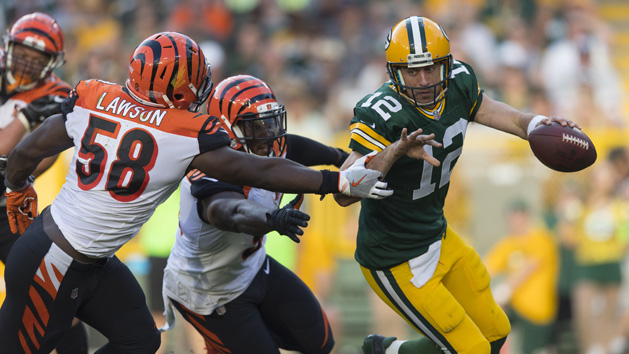 Sep 24, 2017; Green Bay, WI, USA; Green Bay Packers quarterback Aaron Rodgers (12) scrambles under pressure from Cincinnati Bengals linebacker Carl Lawson (58) during the third quarter at Lambeau Field. Photo Credit: Jeff Hanisch-USA TODAY Sports