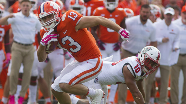 Oct 20, 2018; Clemson, SC, USA; Clemson Tigers wide receiver Hunter Renfrow (13) avoids the tackle by North Carolina State Wolfpack defensive back Tanner Ingle (10) during the first quarter of the game at Clemson Memorial Stadium. Photo Credit: Joshua S. Kelly-USA TODAY Sports
