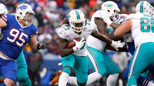 Dec 24, 2016; Orchard Park, NY, USA; Miami Dolphins running back Jay Ajayi (23) runs with the ball past Buffalo Bills defensive end Kyle Williams (95) during the first half at New Era Field. Photo Credit: Kevin Hoffman-USA TODAY Sports