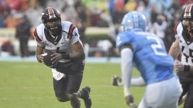 Oct 8, 2016; Chapel Hill, NC, USA; Virginia Tech Hokies quarterback Jerod Evans (4) rolls out before throwing a touchdown pass as North Carolina Tar Heels cornerback Des Lawrence (2) pressures in the second quarter at Kenan Memorial Stadium. Photo Credit: Bob Donnan-USA TODAY Sports
