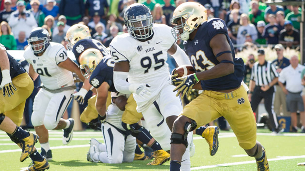 Sep 10, 2016; South Bend, IN, USA; Notre Dame Fighting Irish running back Josh Adams (33) runs the ball as Nevada Wolf Pack defensive end Patrick Choudja (95) defends in the second quarter at Notre Dame Stadium. Photo Credit: Matt Cashore-USA TODAY Sports