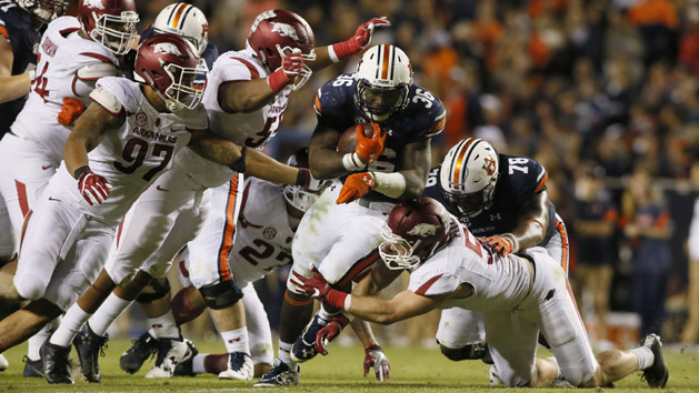Oct 22, 2016; Auburn, AL, USA; Auburn Tigers running back Kamryn Pittway (36) is tackled by Arkansas Razorbacks linemen Tevin Beanum (97), Jeremiah Ledbetter (55) and linebacker Brooks Ellis (55) during the third quarter at Jordan Hare Stadium. The Tigers beat the Razorbacks 56-3. Photo Credit: John Reed-USA TODAY Sports