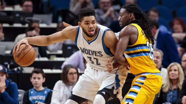 Jan 22, 2017; Minneapolis, MN, USA; Minnesota Timberwolves center Karl-Anthony Towns (32) dribbles in the first quarter against the Denver Nuggets forward Kenneth Faried (35) at Target Center. Mandatory Credit: Brad Rempel-USA TODAY Sports
