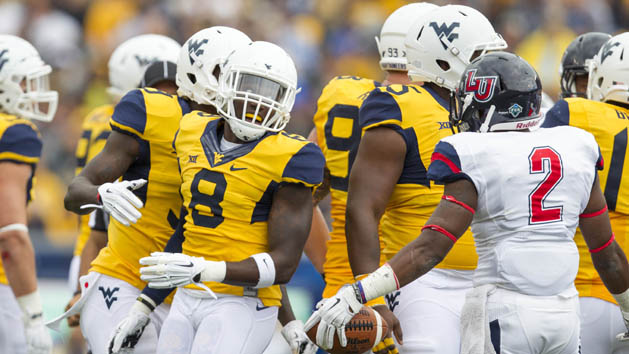 Sep 12, 2015; Morgantown, WV, USA; Liberty Flames running back D.J. Abnar (2) and West Virginia Mountaineers safety Karl Joseph exchange words after a play during the second quarter at Milan Puskar Stadium. Mandatory Credit: Ben Queen-USA TODAY Sports