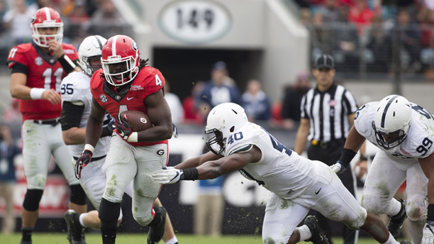 Jan 2, 2016; Jacksonville, FL, USA; Georgia Bulldogs running back Keith Marshall (4) runs for a first down as Penn State Nittany Lions linebacker Jason Cabinda (40) defends in the fourth quarter at EverBank Field. Georgia defeated Penn State 24-17 to win the 2016 TaxSlayer Bowl. Mandatory Credit: Logan Bowles-USA TODAY Sports