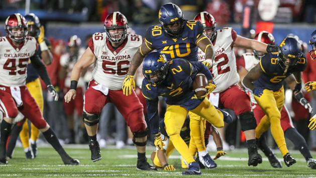 Nov 23, 2018; Morgantown, WV, USA; West Virginia Mountaineers safety Kenny Robinson Jr. (2) recovers a fumble during the second quarter against the Oklahoma Sooners at Mountaineer Field at Milan Puskar Stadium. Photo Credit: Ben Queen-USA TODAY Sports