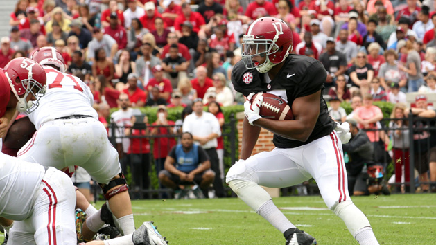 Sep 19, 2015; Tuscaloosa, AL, USA; Alabama Crimson Tide running back Kenyan Drake (17) pushes away Mississippi Rebels defensive back Kailo Moore (13) at Bryant-Denny Stadium. The Rebels defeated the Tide 43-37. Mandatory Credit: Marvin Gentry-USA TODAY Sports