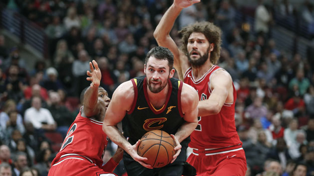 Dec 4, 2017; Chicago, IL, USA; Cleveland Cavaliers forward Kevin Love (0) goes to the basket between Chicago Bulls guard Kris Dunn (32) and center Robin Lopez (42) during the second half at United Center. Photo Credit: Kamil Krzaczynski-USA TODAY Sports