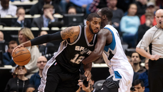 Mar 8, 2016; Minneapolis, MN, USA; San Antonio Spurs forward LaMarcus Aldridge (12) dribbles in the first quarter against the Minnesota Timberwolves center Gorgui Dieng (5) at Target Center. Mandatory Credit: Brad Rempel-USA TODAY Sports