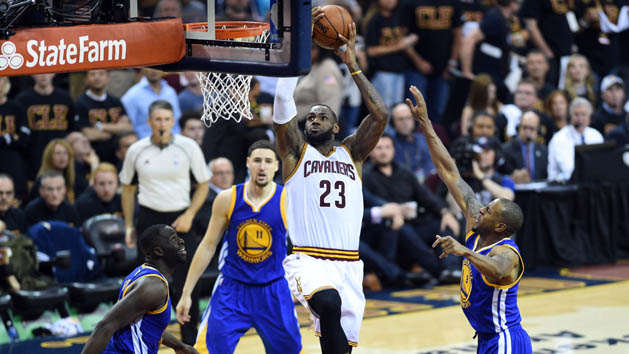 Jun 16, 2016; Cleveland, OH, USA; Cleveland Cavaliers forward LeBron James (23) dunks the ball against Golden State Warriors forward Andre Iguodala (9) and forward Draymond Green (23) during the third quarter in game six of the NBA Finals at Quicken Loans Arena. Mandatory Credit: Bob Donnan-USA TODAY Sports