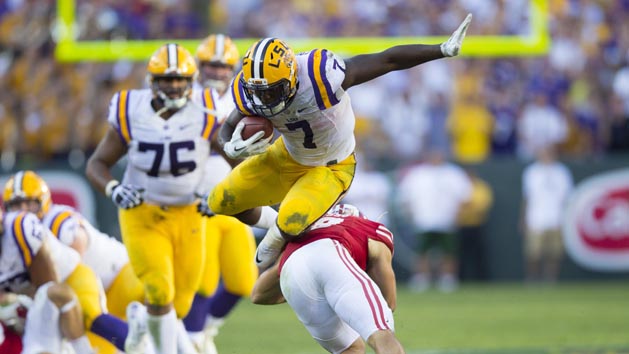 Sep 3, 2016; Green Bay, WI, USA; LSU Tigers running back Leonard Fournette (7) leaps over Wisconsin Badgers safety Leo Musso (19) during the fourth quarter at Lambeau Field. Photo Credit: Jeff Hanisch-USA TODAY Sports