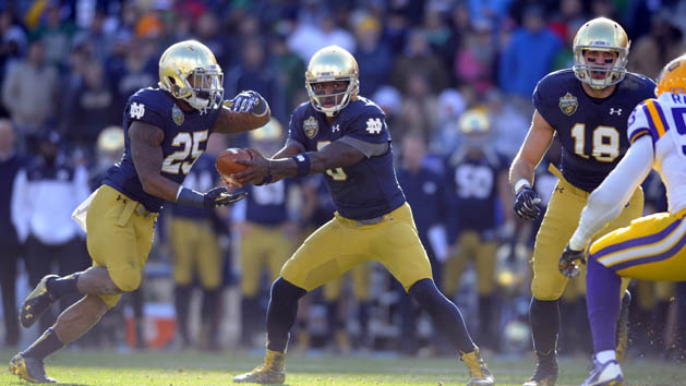 Notre Dame quarterback Malik Zaire (8) hands the ball off to running back Tarean Folston (25) during the first half against the LSU Tigers in the Music City Bowl at LP Field. (Christopher Hanewinckel-USA TODAY Sports)