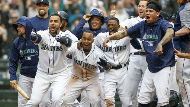 Jun 13, 2018; Seattle, WA, USA; Seattle Mariners designated hitter Nelson Cruz (23, left), shortstop Jean Segura (2), second baseman Dee Gordon (9) and starting pitcher Felix Hernandez (34, right) wait at home plate following a walk-off two-run homer by right fielder Mitch Haniger (17, not pictured) against the Los Angeles Angels during the ninth inning at Safeco Field. Segura scored on the hit. Seattle defeated Los Angeles, 8-6. Photo Credit: Joe Nicholson-USA TODAY Sports