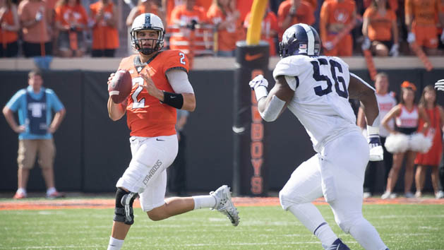 Sep 23, 2017; Stillwater, OK, USA; Oklahoma State Cowboys quarterback Mason Rudolph (2) is pressured by TCU Horned Frogs defensive tackle Chris Bradley (56) during the first half at Boone Pickens Stadium. Photo Credit: Rob Ferguson-USA TODAY Sports