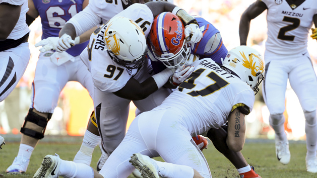 Nov 3, 2018; Gainesville, FL, USA; Missouri Tigers linebacker Cale Garrett (47) and Missouri Tigers defensive lineman Akial Byers (97) tackle Florida Gators running back Lamical Perine (22) during the first quarter at Ben Hill Griffin Stadium. Photo Credit: Kim Klement-USA TODAY Sports