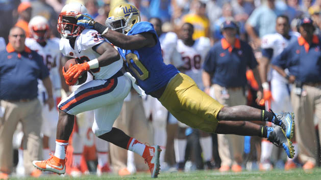 September 5, 2015; Pasadena, CA, USA; Virginia Cavaliers running back Olamide Zaccheaus (33) runs the ball against the defense of UCLA Bruins linebacker Myles Jack (30) during the first half at the Rose Bowl. Mandatory Credit: Gary A. Vasquez-USA TODAY Sports