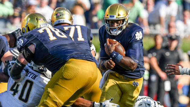 Sep 15, 2018; South Bend, IN, USA; Notre Dame Fighting Irish quarterback Brandon Wimbush (7) runs the ball as Vanderbilt Commodores linebacker Jordan Griffin (40) attempts to tackle in the fourth quarter at Notre Dame Stadium. Photo Credit: Matt Cashore-USA TODAY Sports