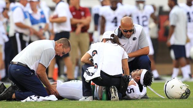 Sep 5, 2015; Philadelphia, PA, USA; Penn State Nittany Lions linebacker Nyeem Wartman-White (5) reacts while trainers work on his leg as head coach James Franklin looks during the second quarter against the Temple Owl at Lincoln Financial Field. Mandatory Credit: Matthew O'Haren-USA TODAY Sports