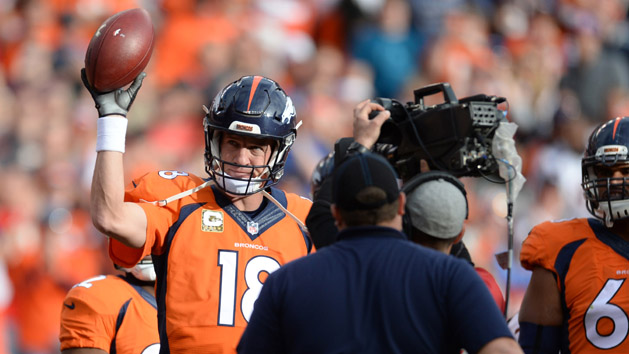 Nov 15, 2015; Denver, CO, USA; Denver Broncos quarterback Peyton Manning (18) holds up the football after setting the all-time NFL passing yardage record in the first quarter of a game against the Kansas City Chiefs at Sports Authority Field at Mile High. Mandatory Credit: Ron Chenoy-USA TODAY Sports