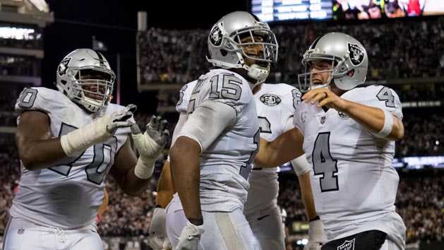 Oct 19, 2017; Oakland, CA, USA; Oakland Raiders wide receiver Michael Crabtree (15) celebrates with quarterback Derek Carr (4) after scoring the game tying touchdown against the Kansas City Chiefs during the fourth quarter at Oakland Coliseum. Photo Credit: Kelley L Cox-USA TODAY Sports