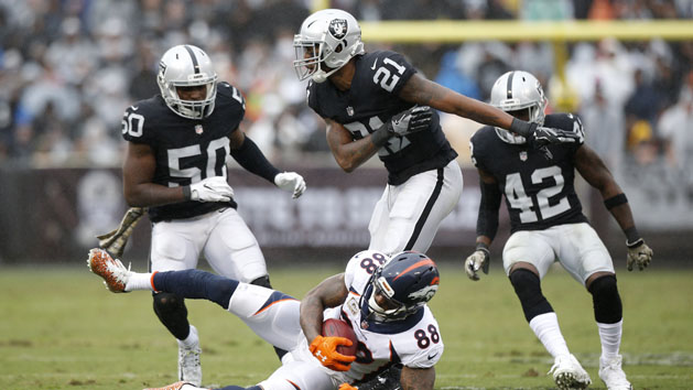 Nov 26, 2017; Oakland, CA, USA; Denver Broncos wide receiver Demaryius Thomas (88) is tackled by Oakland Raiders cornerback Sean Smith (21) in the second quarter at Oakland Coliseum. Photo Credit: Cary Edmondson-USA TODAY Sports