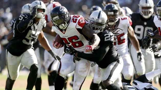 Sep 18, 2016; Oakland, CA, USA; Atlanta Falcons running back Tevin Coleman (26) scores a touchdown in front of Oakland Raiders free safety Reggie Nelson (27) in the fourth quarter at Oakland-Alameda County Coliseum. The Falcons defeated the Raiders 35-28. Photo Credit: Cary Edmondson-USA TODAY Sports