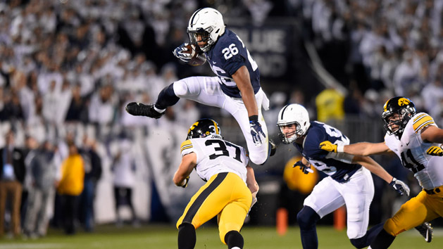 Nov 5, 2016; University Park, PA, USA; Penn State Nittany Lions running back Saquon Barkley (26) leaps over Iowa Hawkeyes defensive back Brandon Snyder (37) during the first quarter at Beaver Stadium. Photo Credit: Rich Barnes-USA TODAY Sports