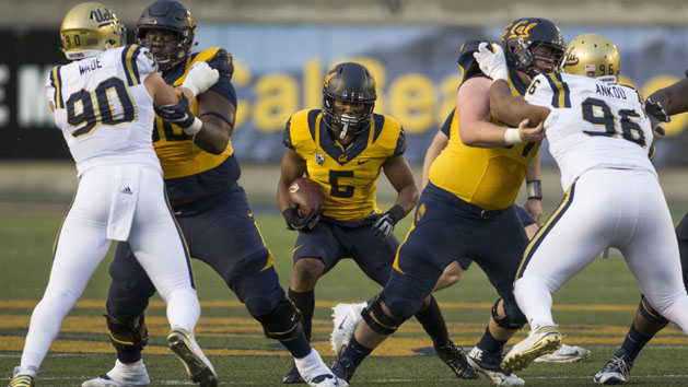 Nov 26, 2016; Berkeley, CA, USA; California Golden Bears running back Tre Watson (5) rushes with the football against UCLA Bruins defensive lineman Eli Ankou (96) and defensive lineman Rick Wade (90) during the first quarter at Memorial Stadium. Photo Credit: Neville E. Guard-USA TODAY Sports