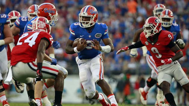 Oct 31, 2015; Jacksonville, FL, USA; Florida Gators quarterback Treon Harris (3) runs with the ball as Georgia Bulldogs safety Dominick Sanders (24) and cornerback Reggie Wilkerson (9) defends during the second half at EverBank Stadium. Florida Gators defeated the Georgia Bulldogs 27-3. Photo Credit: Kim Klement-USA TODAY Sports