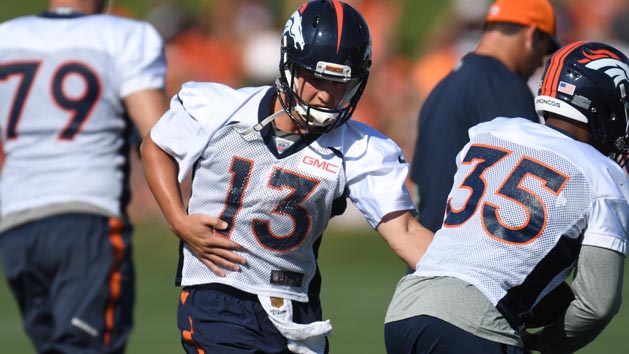 Jul 28, 2016; Englewood, CO, USA; Denver Broncos quarterback Trevor Siemian (13) hands off the ball to running back Kapri Bibbs (35) during training camp drills held at the UCHealth Training Center. Photo Credit: Ron Chenoy-USA TODAY Sports